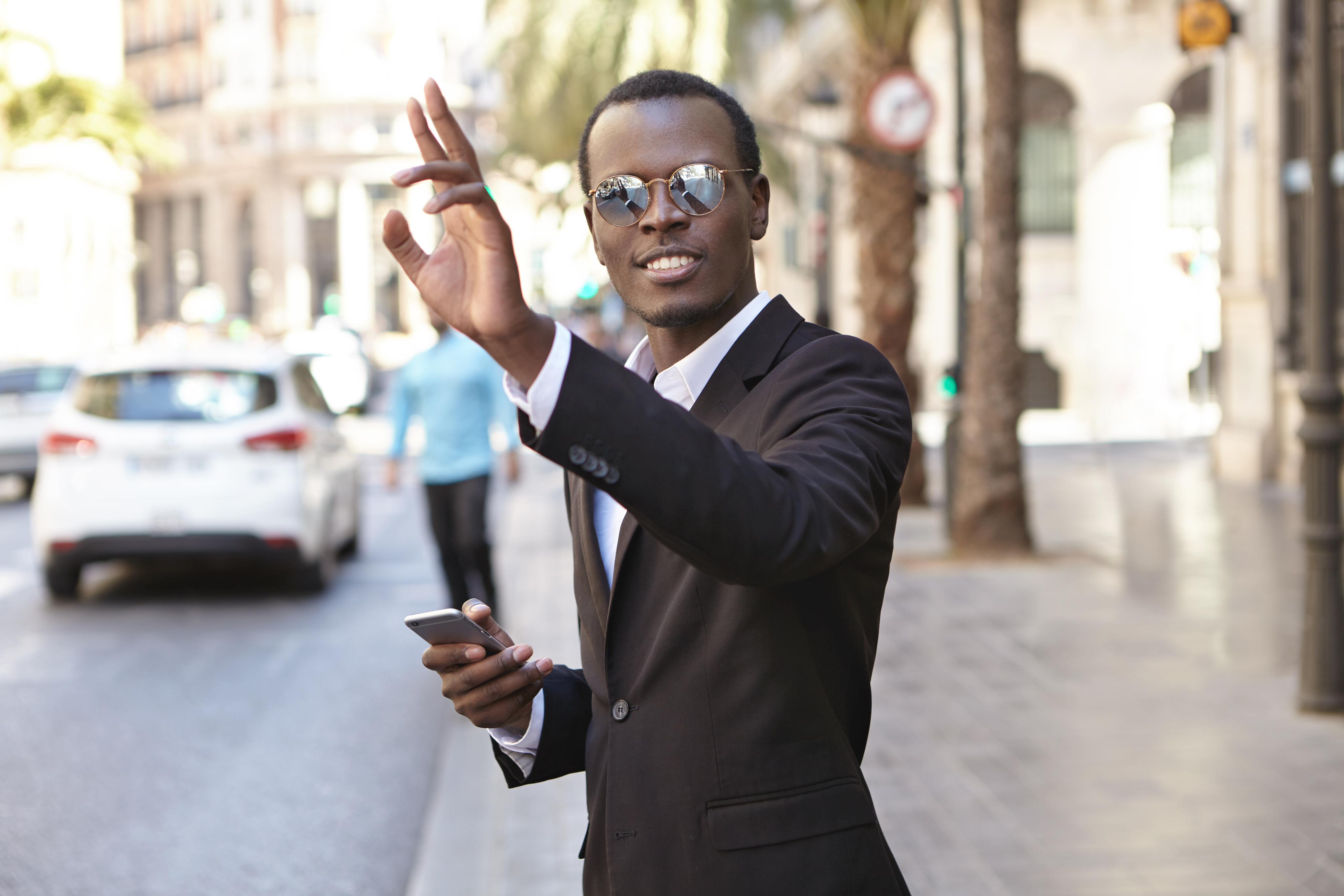 Rider waving near car